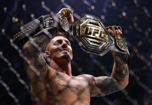 Tom Aspinall poses with the UFC heavyweight championship belt