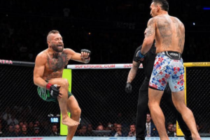 Conor McGregor sits injured in the octagon during his UFC 329 comeback fight.