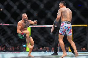 Conor McGregor reacts after suffering a knee injury during UFC 329 against Max Holloway.